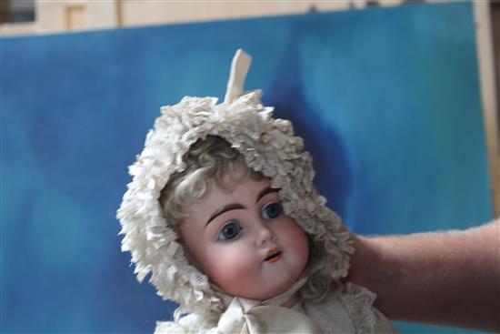 A Kestner 192 doll, fixed wrists, pierced ears and hairline to forehead, 24in.